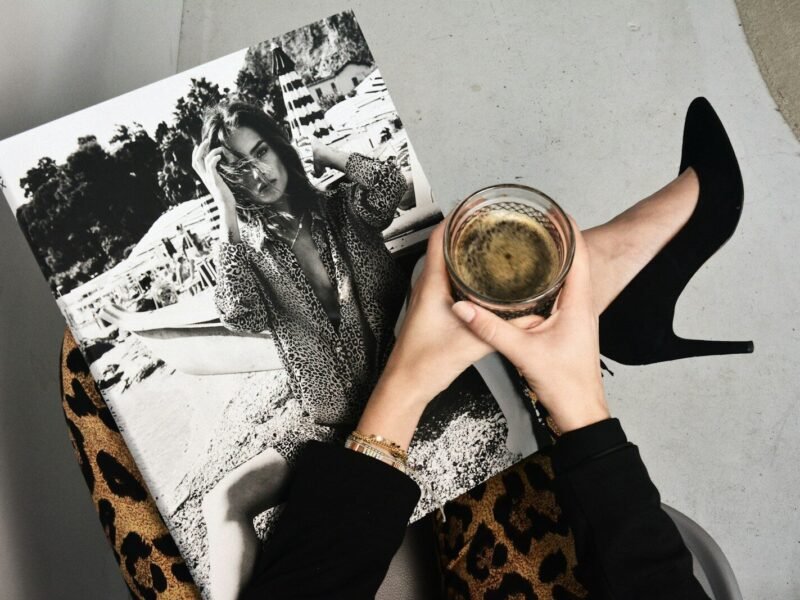 woman holding clear glass candle holder and grayscale portrait of a woman